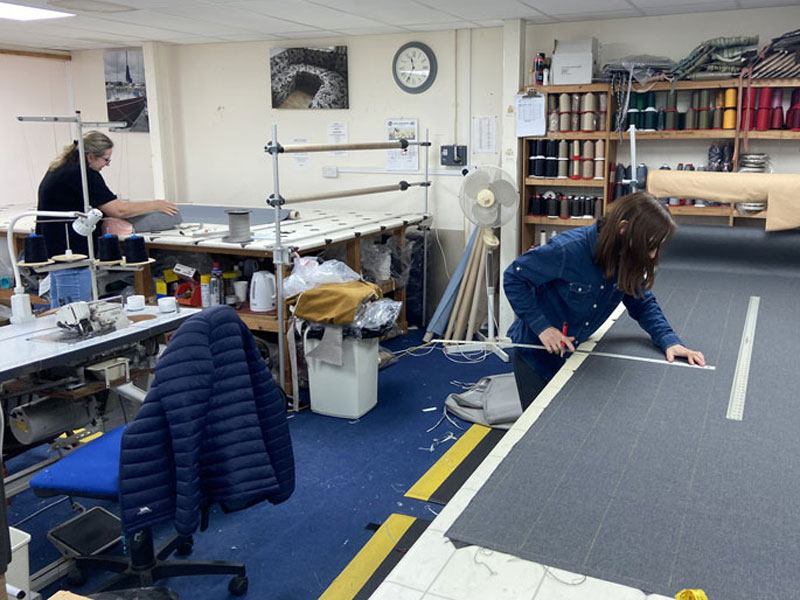 Skilled cutters mark and intricate fabric shapes at the start of the sewing process