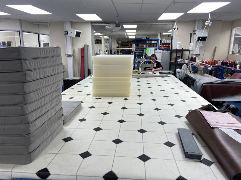 A bespoke foam cushion order being completed by a skilled machinist
